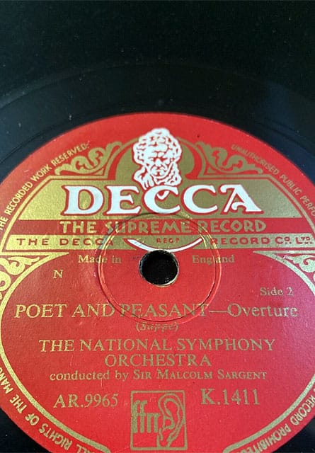 A red Decca 78rpm record label reading “Poet and Peasant — Overture (Suppé), The National Symphony Orchestra, conducted by Sir Malcolm Sargent”, catalogue number K.1411.